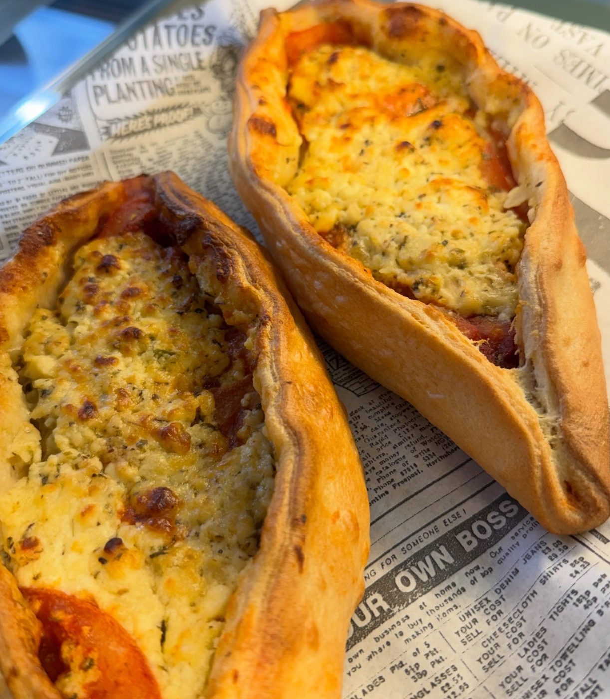 Two golden cheese peinirli, a vegetarian Greek cheese-filled dough, fresh from the counter at The Greek Spot in Middlesbrough
