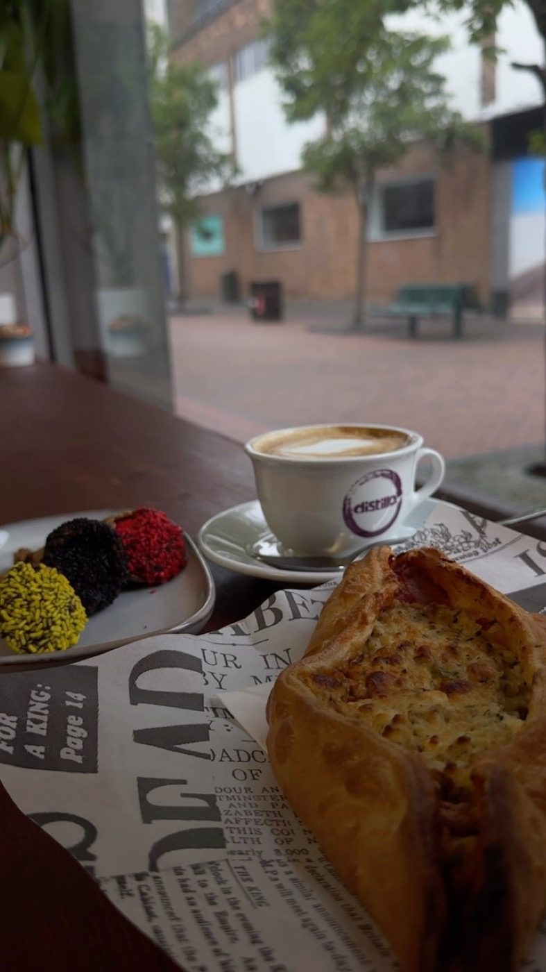 Peinirli and a cappuccino on the window bench at The Greek Spot looking onto Dundas Street in Middlesbrough